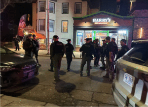 Police personnel stand guard near the scene of a reported mass shooting at Brown University in Providence, Rhode Island, on December 13, 2025.